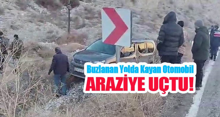 Buzlanan yolda kayan otomobil araziye uçtu..